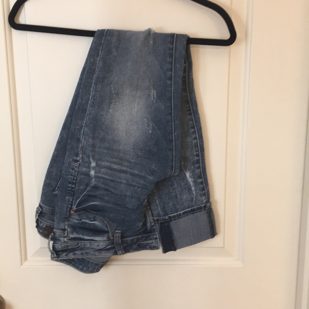 Medium wash heavy distressed jeans